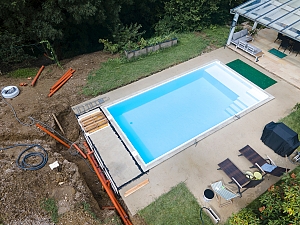 Vinyl pool being installed in backyard