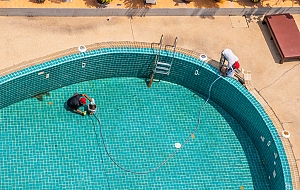 men renovating pool