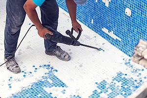 pool renovator removing tile